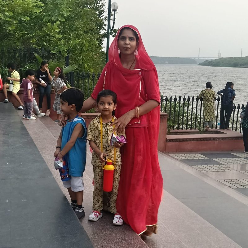 A caregiver with two children during an outing
