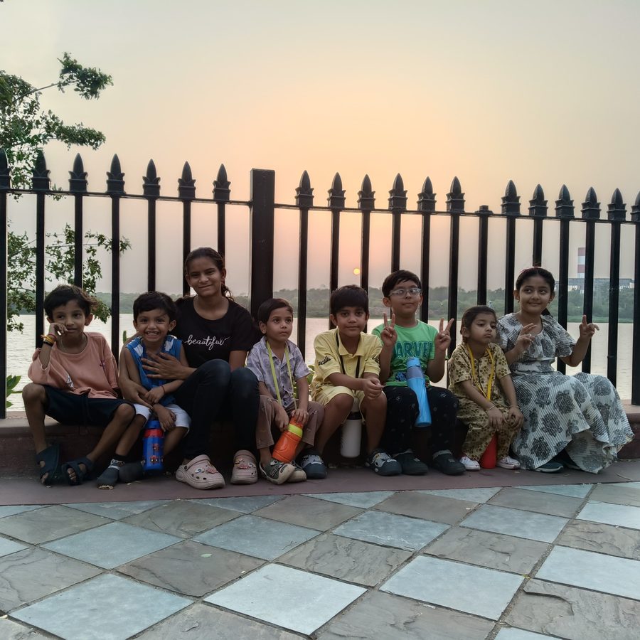 A group of children on a sunset outing by the lake